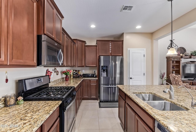 42915 W Kingfisher Dr, Maricopa, AZ 85138 - kitchen featuring a sink, pendant lighting, stainless steel appliances, light stone countertops, and visible vents