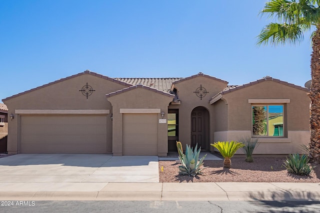 42915 W Kingfisher Dr, Maricopa, AZ 85138 - mediterranean / spanish home featuring a garage, a tile roof, concrete driveway, and stucco siding