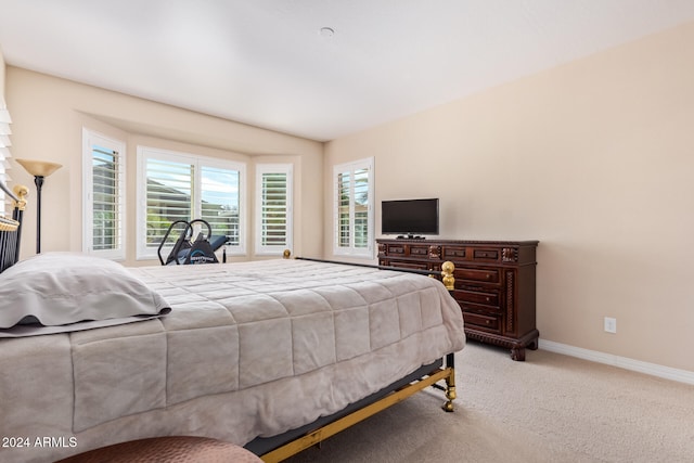 bedroom featuring light carpet