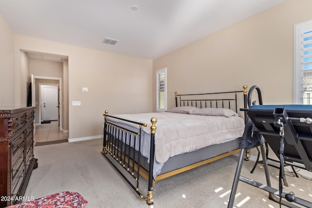 carpeted bedroom featuring multiple windows