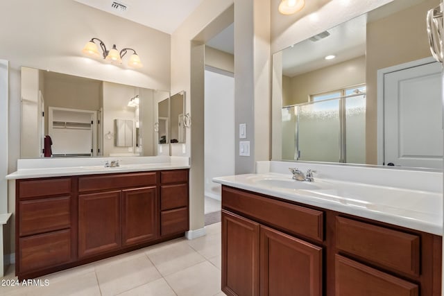 42915 W Kingfisher Dr, Maricopa, AZ 85138 - bathroom with a shower stall, tile patterned flooring, visible vents, a sink, and two vanities
