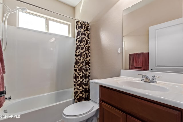 full bathroom with vanity, shower / bath combo, and toilet