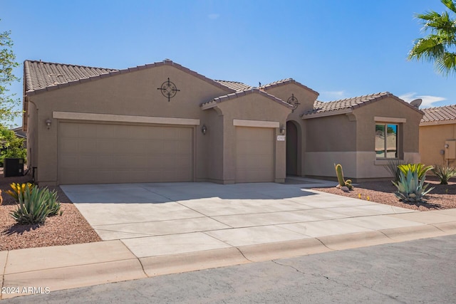 42915 W Kingfisher Dr, Maricopa, AZ 85138 - view of front of house with central air condition unit, driveway, a tiled roof, an attached garage, and stucco siding