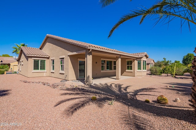 42915 W Kingfisher Dr, Maricopa, AZ 85138 - back of house with a tile roof, a patio, and stucco siding