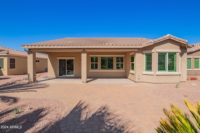 back of property with a patio