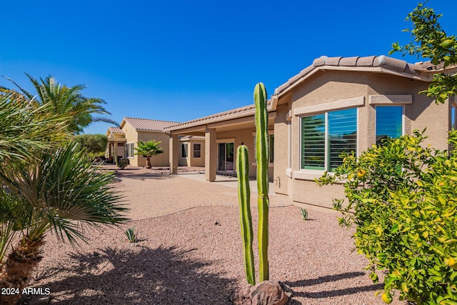 42915 W Kingfisher Dr, Maricopa, AZ 85138 - back of house with stucco siding, a tiled roof, and a patio