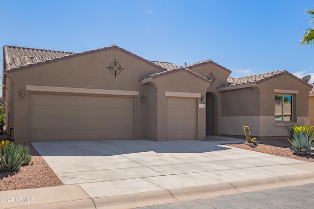 mediterranean / spanish home featuring a garage