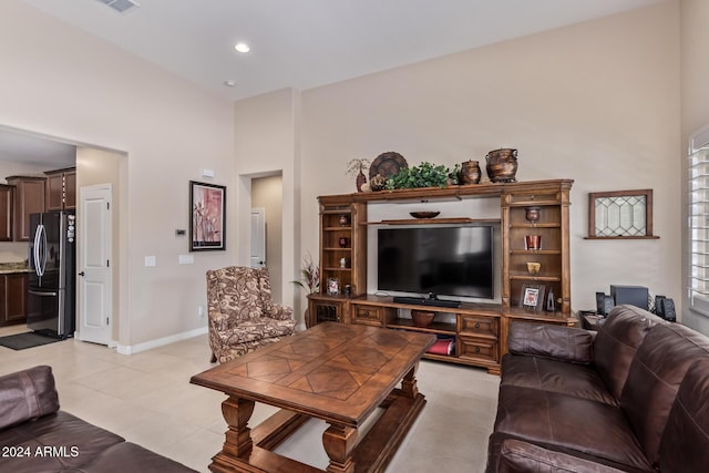 42915 W Kingfisher Dr, Maricopa, AZ 85138 - living area featuring light tile patterned flooring, a high ceiling, baseboards, and recessed lighting