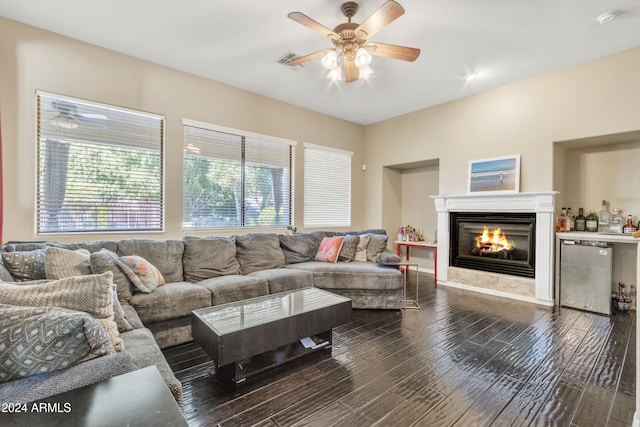 living room featuring ceiling fan and dark hardwood / wood-style flooring