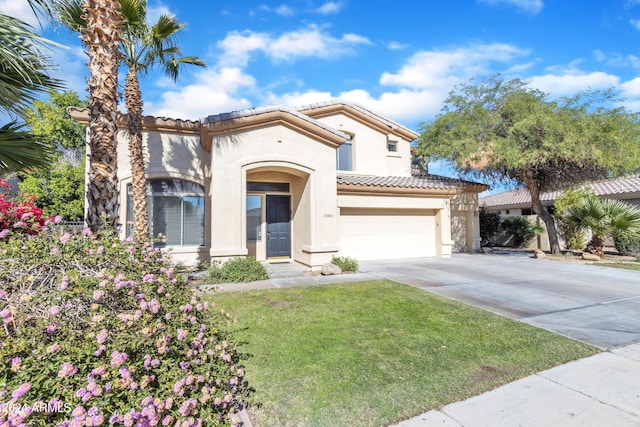 14462 W Avalon Dr, Goodyear, AZ 85395 - mediterranean / spanish-style house with stucco siding, a tiled roof, driveway, a front yard, and a garage