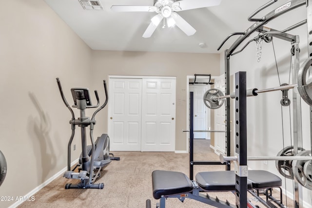 exercise area featuring ceiling fan and light carpet