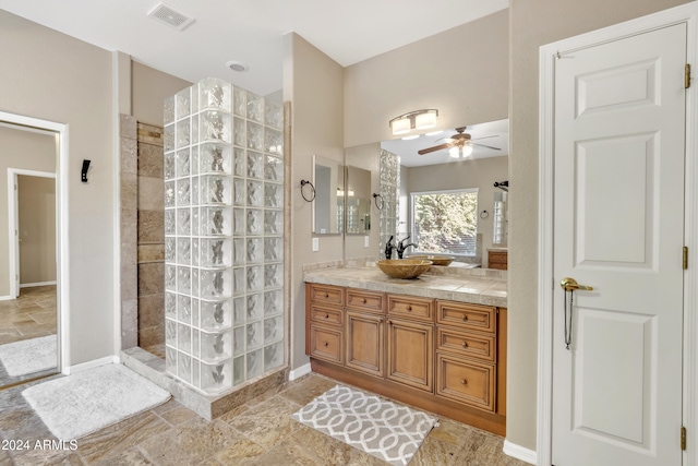 bathroom featuring tiled shower, vanity, and ceiling fan