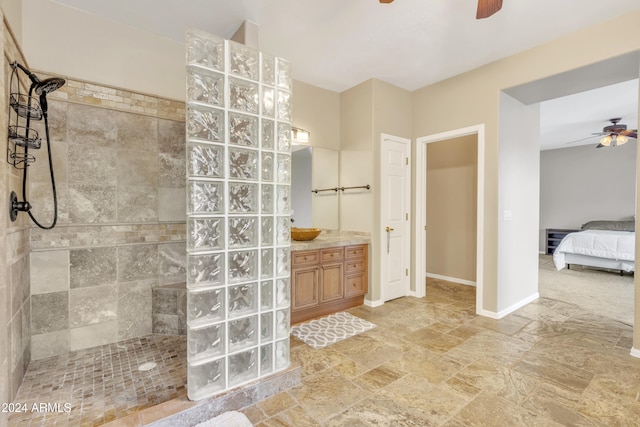 14462 W Avalon Dr, Goodyear, AZ 85395 - ensuite bathroom featuring a ceiling fan, walk in shower, vanity, and stone finish floors