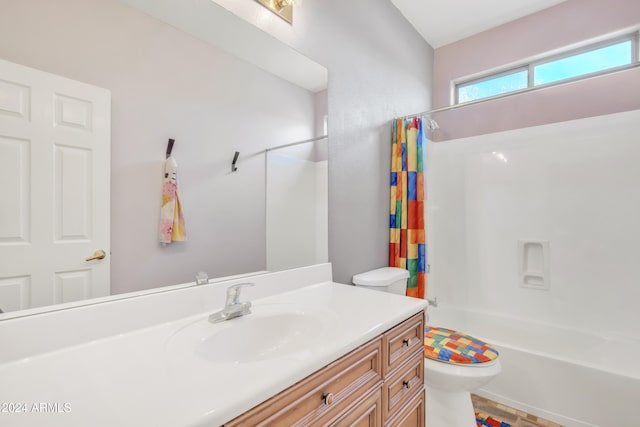 full bathroom with vanity, shower / tub combo, and toilet