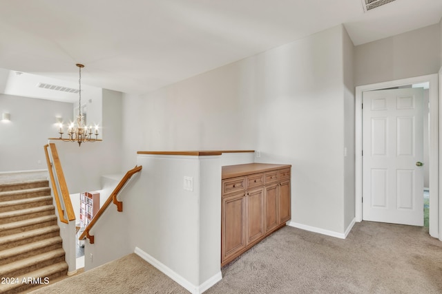 14462 W Avalon Dr, Goodyear, AZ 85395 - corridor with light colored carpet, a chandelier, and an upstairs landing