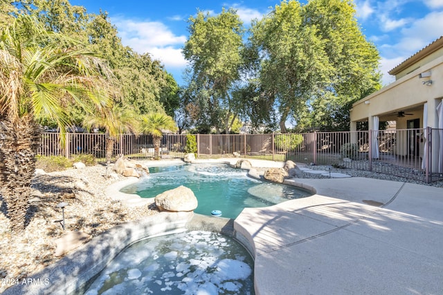 view of pool featuring ceiling fan, a jacuzzi, and a patio