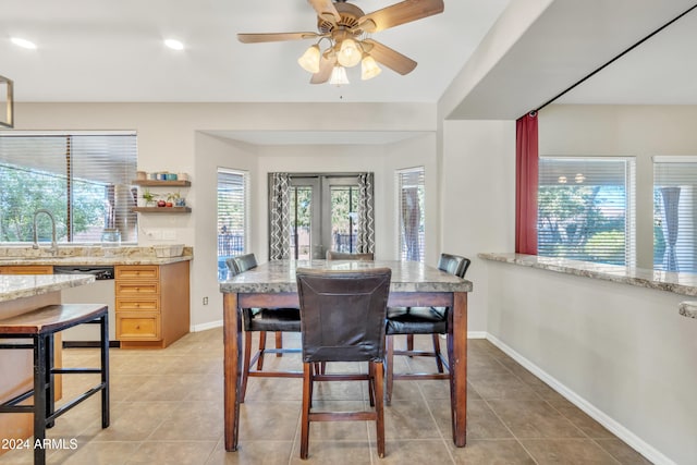 tiled dining area with french doors, sink, a wealth of natural light, and ceiling fan