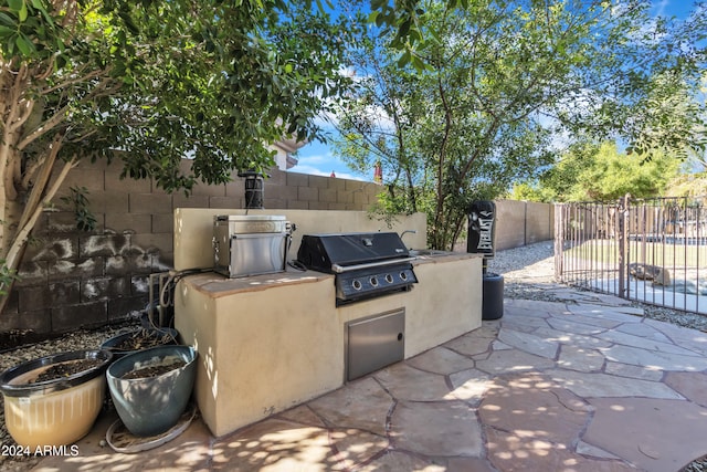 view of patio featuring area for grilling and a grill