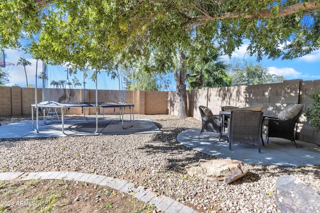 14462 W Avalon Dr, Goodyear, AZ 85395 - fenced backyard with a trampoline and a patio area