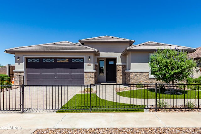 prairie-style home with a front yard and a garage