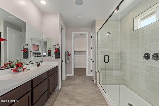 bathroom with vanity and a shower with shower door