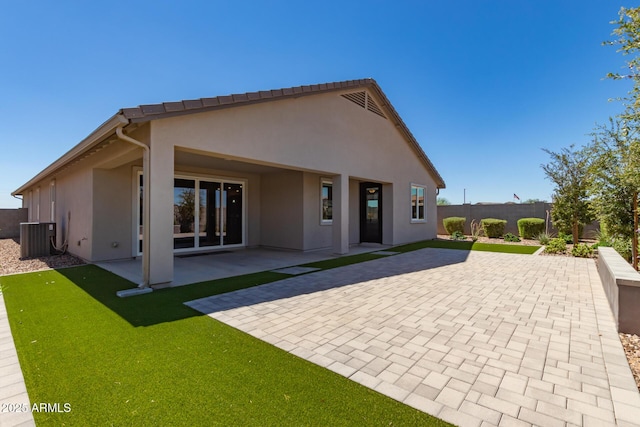 back of house featuring central air condition unit and a patio