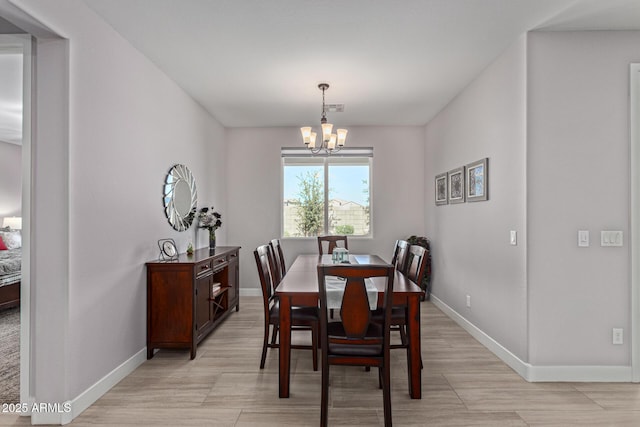 dining area with an inviting chandelier