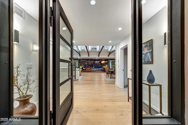 hall featuring recessed lighting, visible vents, and light wood-type flooring