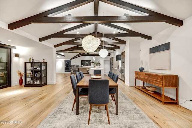 dining area with light wood finished floors, lofted ceiling with beams, and baseboards