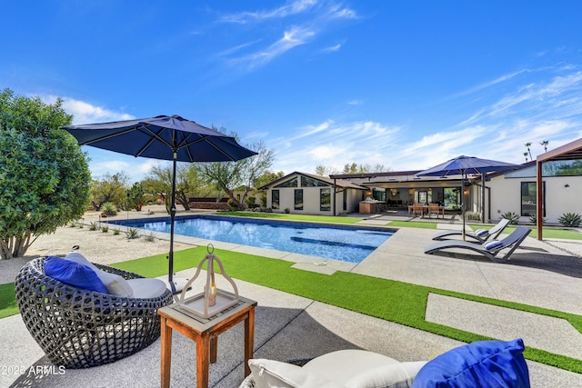 outdoor pool featuring an outdoor structure and a patio