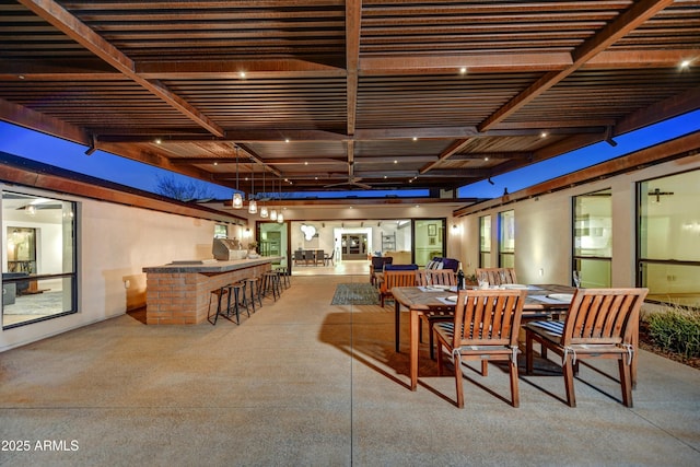 view of patio / terrace featuring outdoor dry bar, outdoor dining space, an outdoor kitchen, and a pergola