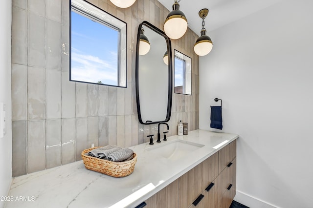 bathroom featuring vanity, tile walls, and backsplash