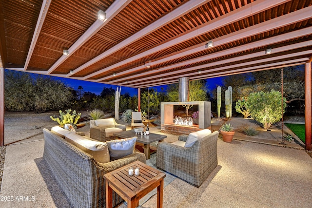 view of patio / terrace with an outdoor living space with a fireplace