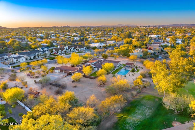 aerial view at dusk featuring a residential view