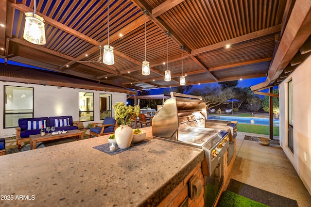 view of patio featuring exterior kitchen and ceiling fan