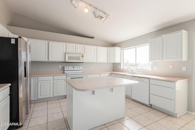 21 E Irvine Rd, Phoenix, AZ 85086 - kitchen with white appliances, vaulted ceiling, light countertops, and white cabinetry