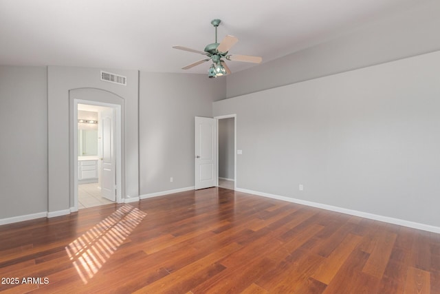 21 E Irvine Rd, Phoenix, AZ 85086 - unfurnished bedroom with wood finished floors, ensuite bath, and a ceiling fan