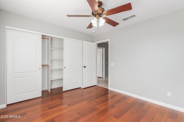 21 E Irvine Rd, Phoenix, AZ 85086 - unfurnished bedroom with wood finished floors, a closet, and a ceiling fan