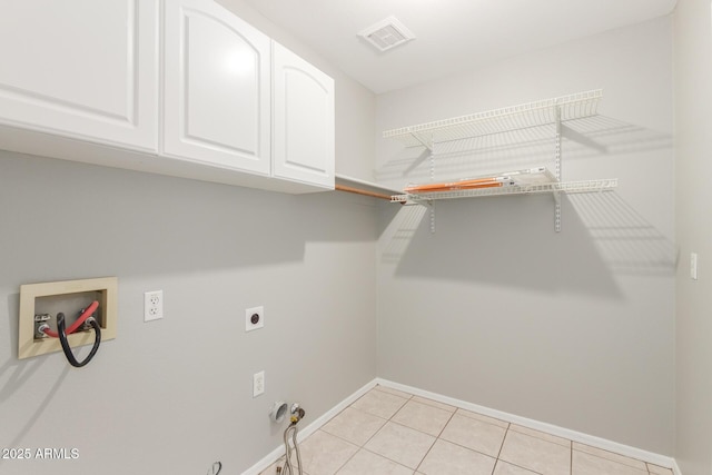 21 E Irvine Rd, Phoenix, AZ 85086 - laundry room featuring cabinet space, washer hookup, gas dryer hookup, hookup for an electric dryer, and light tile patterned floors