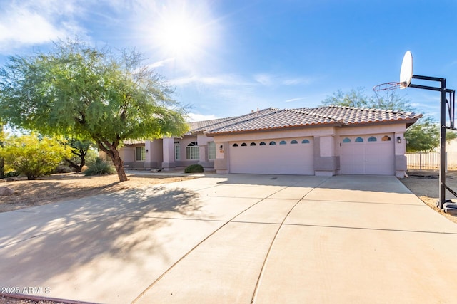21 E Irvine Rd, Phoenix, AZ 85086 - mediterranean / spanish-style home featuring stucco siding, driveway, a tiled roof, and a garage