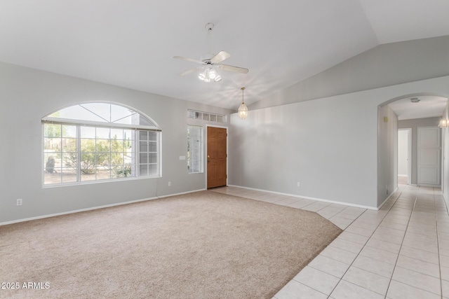 21 E Irvine Rd, Phoenix, AZ 85086 - unfurnished room featuring a ceiling fan, arched walkways, lofted ceiling, light tile patterned floors, and light colored carpet