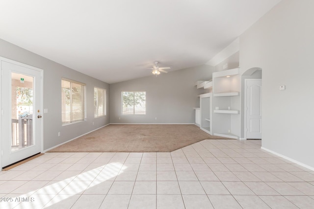 21 E Irvine Rd, Phoenix, AZ 85086 - unfurnished living room featuring vaulted ceiling, a ceiling fan, plenty of natural light, light colored carpet, and arched walkways