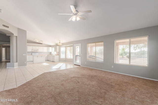 21 E Irvine Rd, Phoenix, AZ 85086 - unfurnished living room featuring arched walkways, light tile patterned floors, ceiling fan, light colored carpet, and high vaulted ceiling