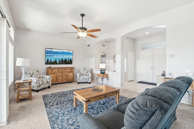 carpeted living room with ceiling fan