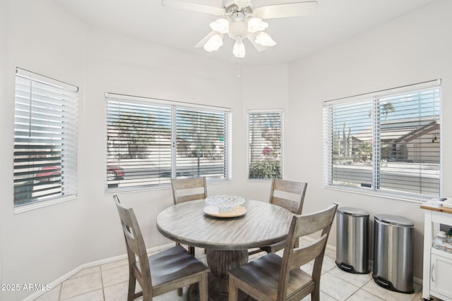 tiled dining area featuring ceiling fan