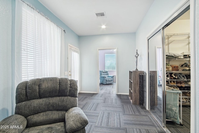 living area with dark carpet