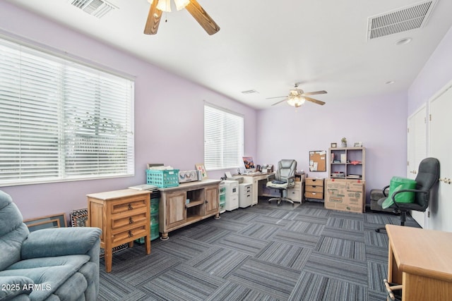 carpeted office featuring ceiling fan