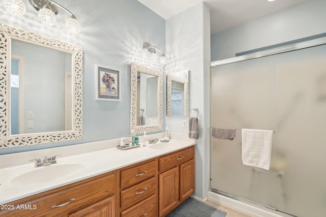 bathroom with vanity and a shower with shower door