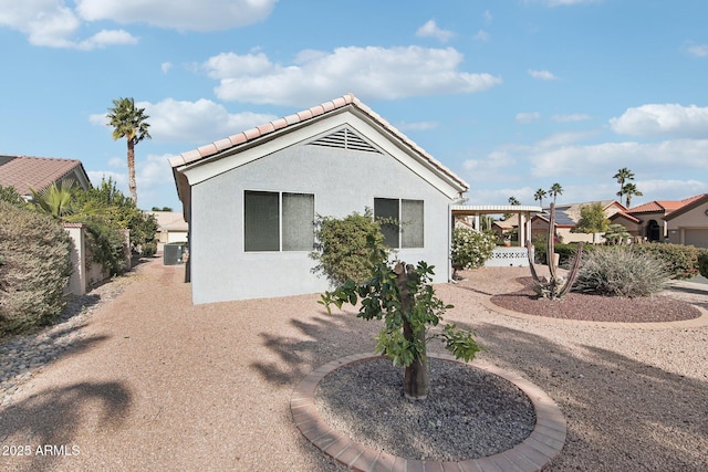 rear view of property with cooling unit and a pergola