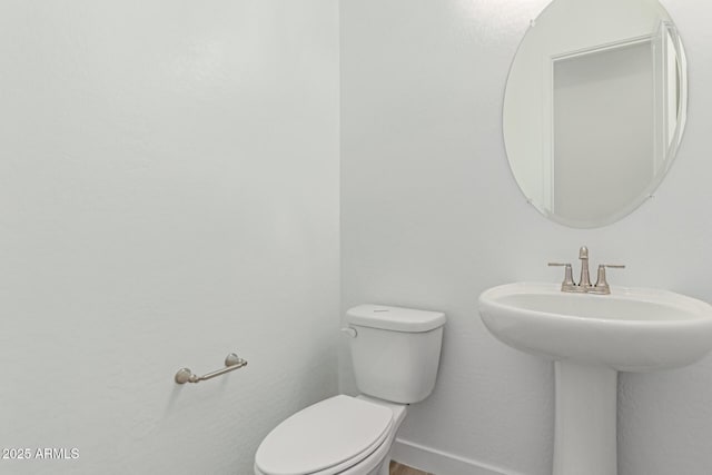 21952 E Saddle Ct E, Queen Creek, AZ 85142 - half bathroom with toilet, baseboards, and a sink